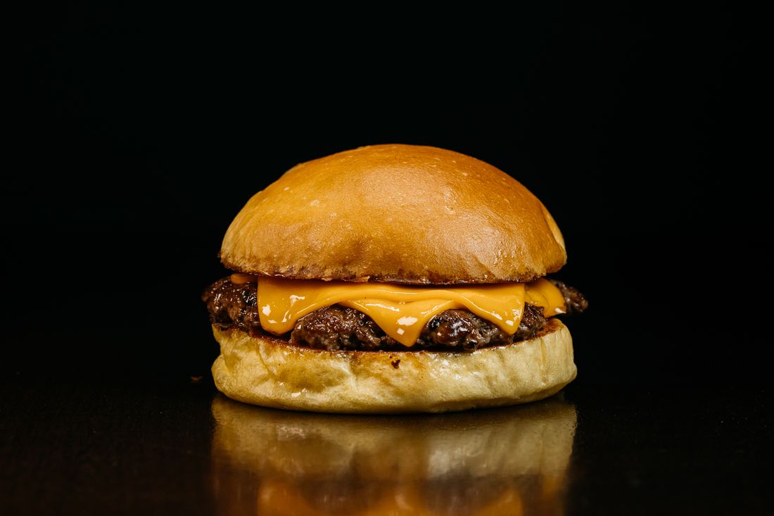 Gourmet cheeseburger with melted cheese and toppings