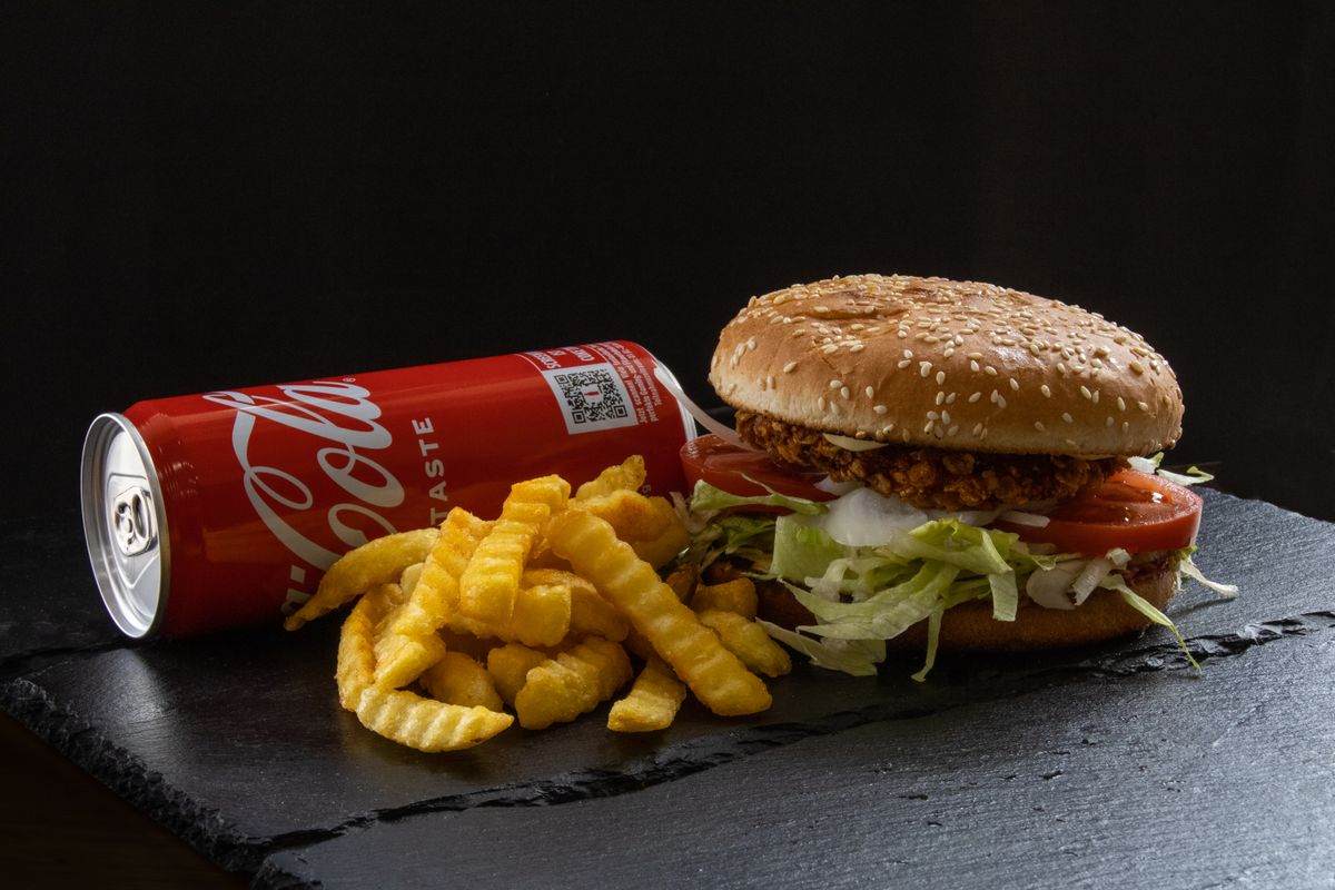 Gourmet chicken burger with melted cheese and toppings