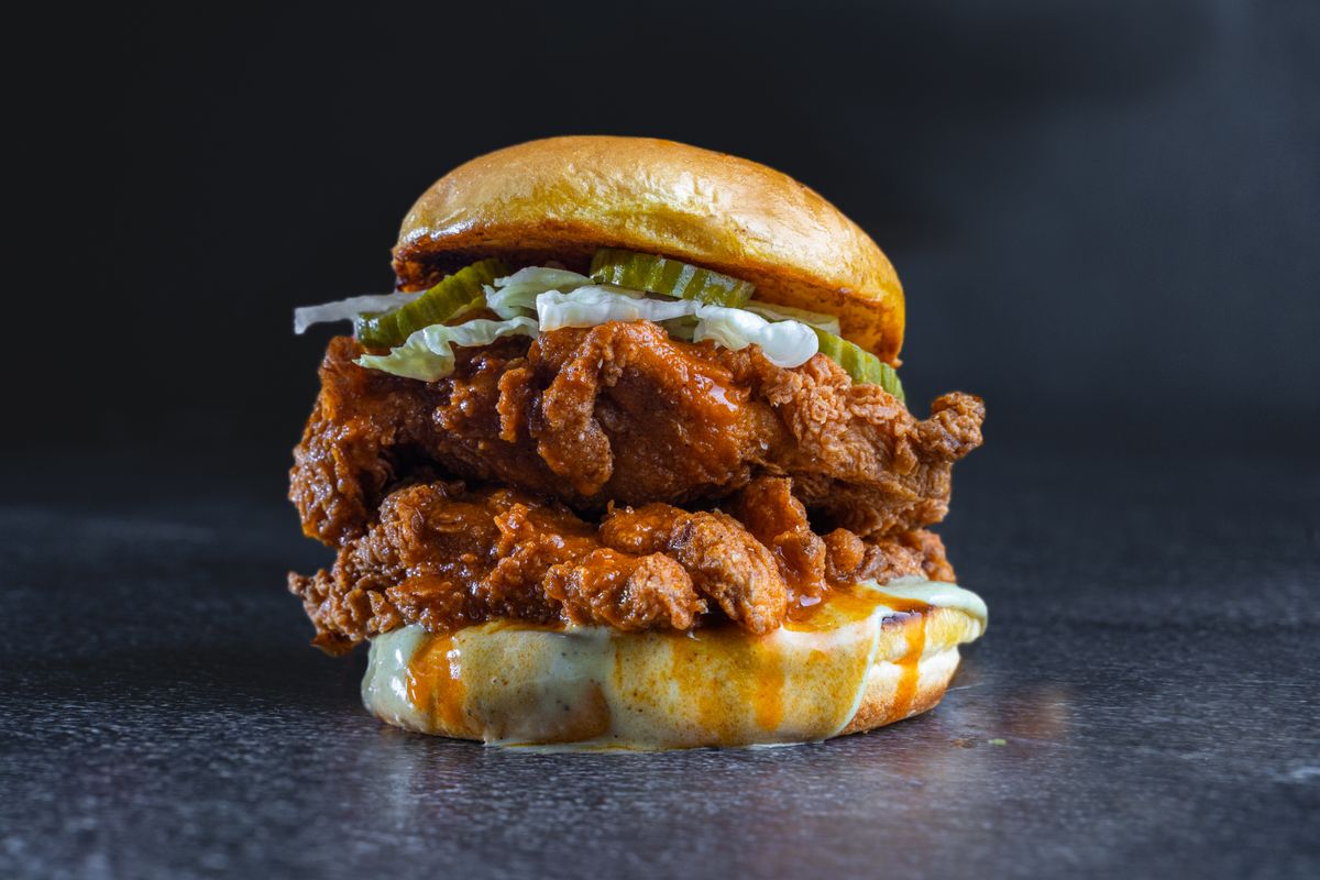 Finished chicken burger with melted cheese and brioche bun