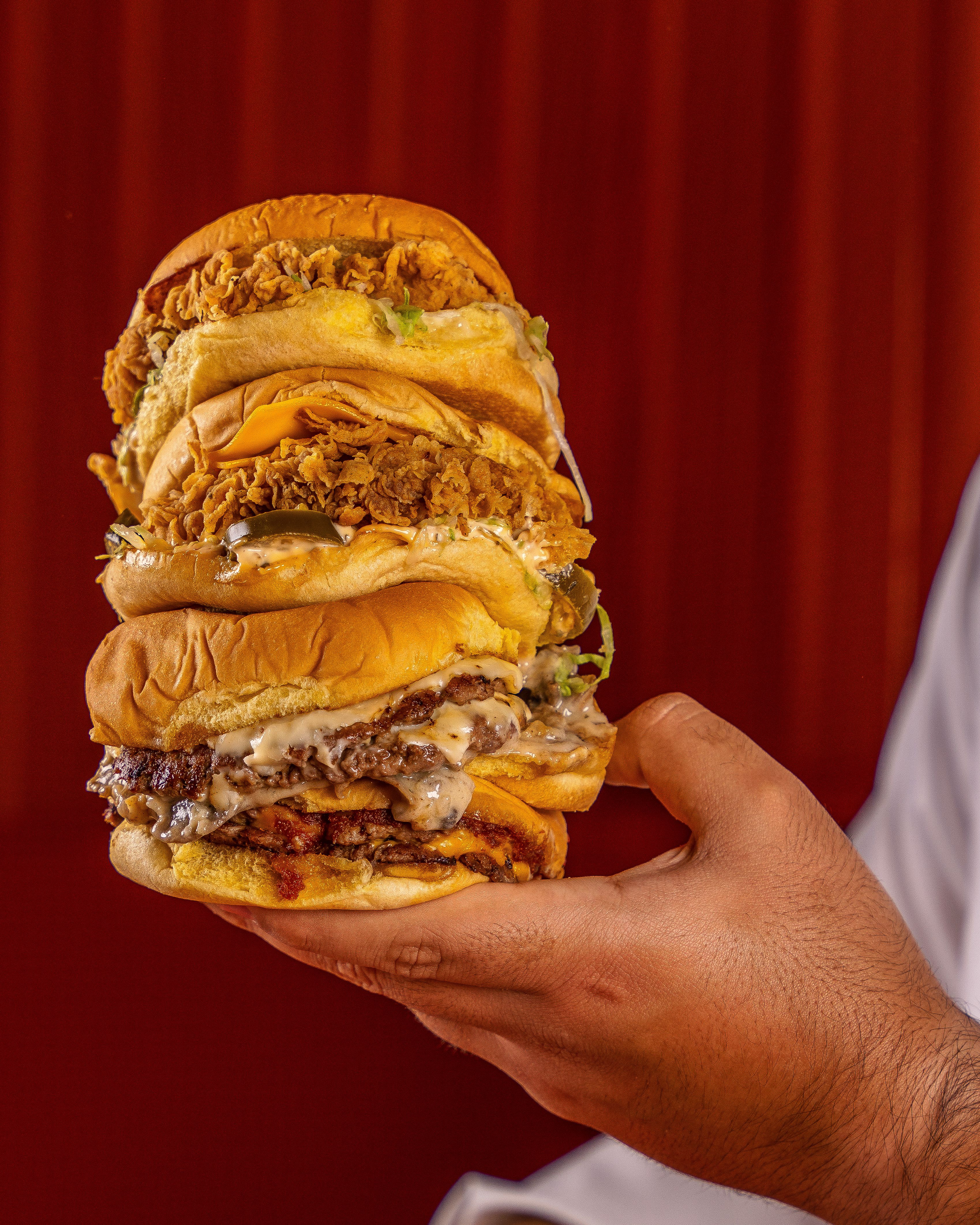 Stacked loaded burger with toasted bun and cheese