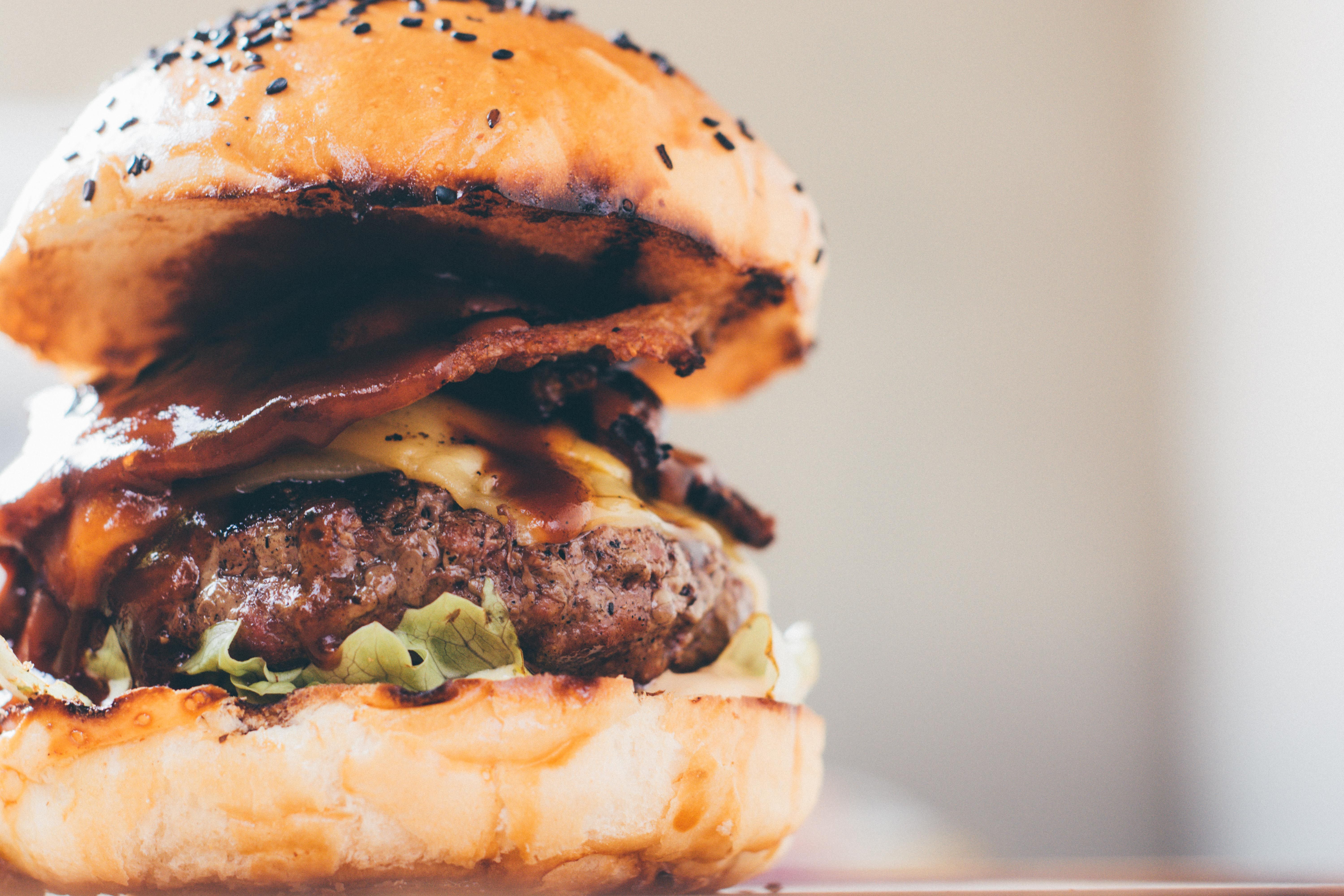 Finished loaded burger with bacon cheese and toppings