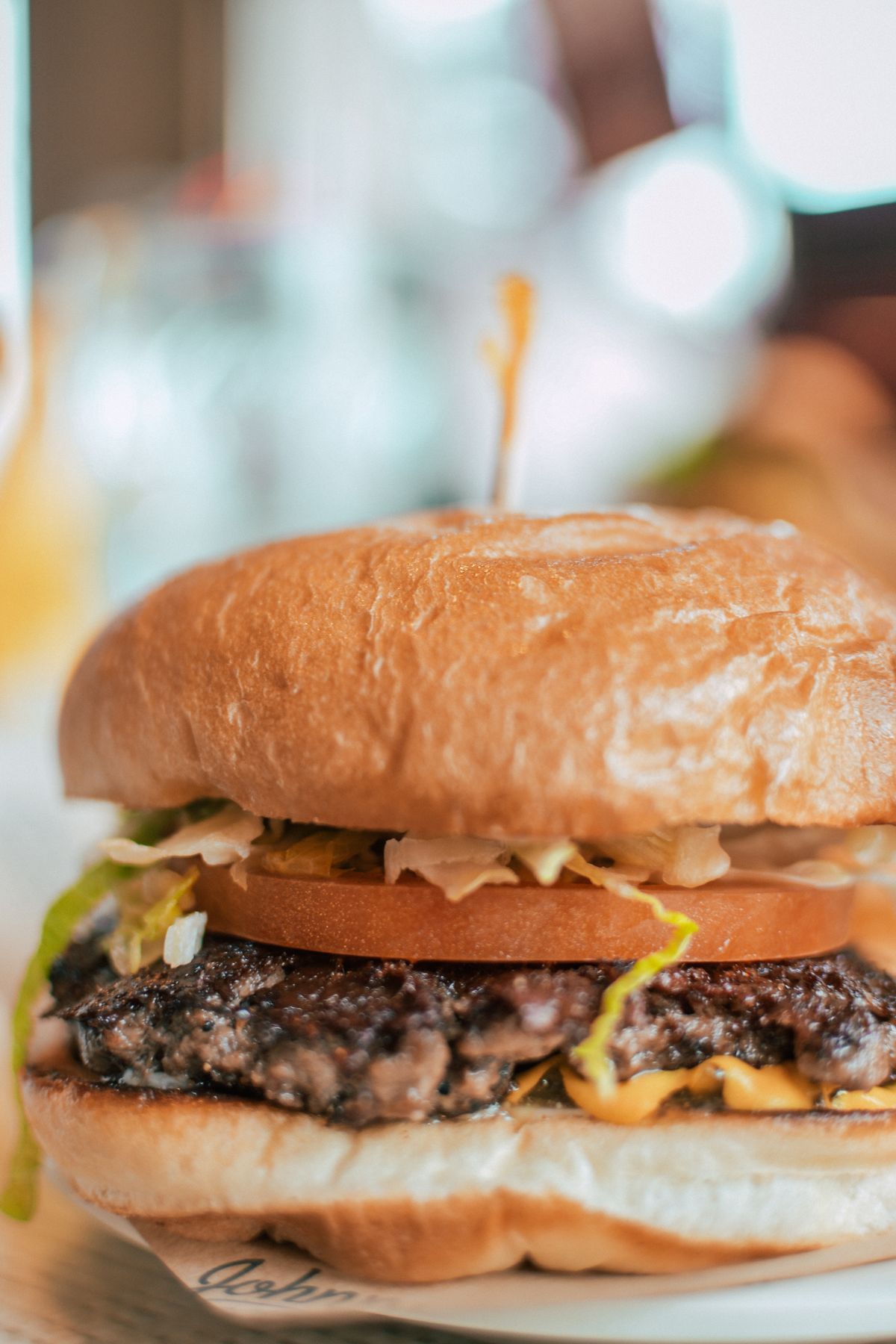 Gourmet spicy burger with melted cheese and toppings
