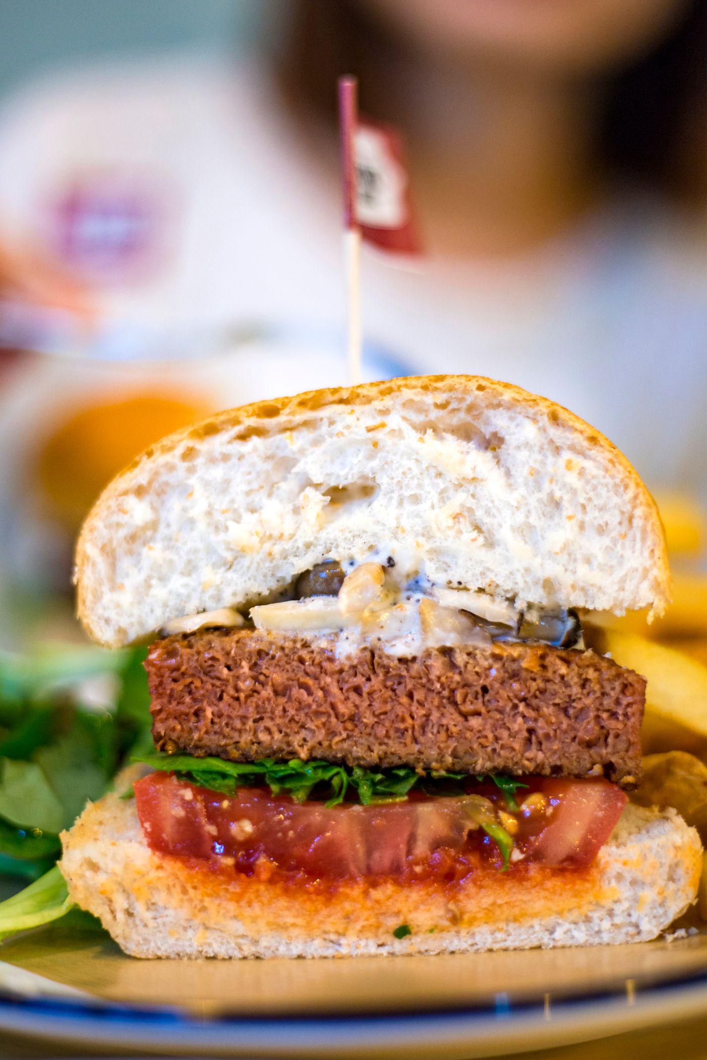 Beef burger patty cooking in a skillet