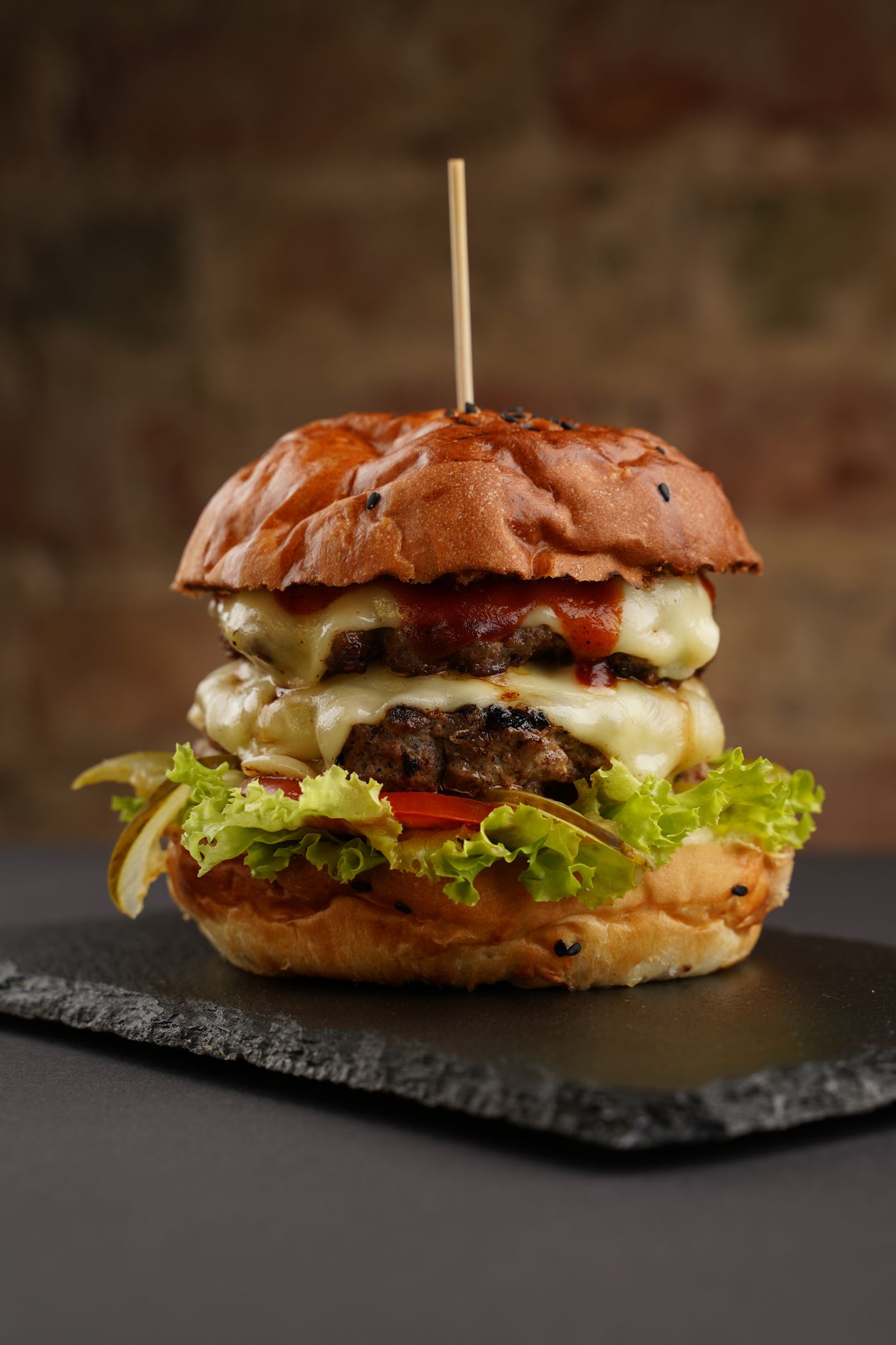 Finished veg burger with melted cheese and brioche bun